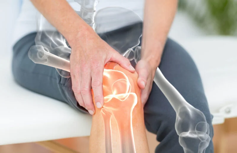 Mid section of man suffering with knee pain