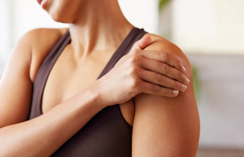 Hands, woman and discomfort of shoulder pain from pilates accident, inflammation and cramp. Female person, massage and joint injury from fitness, muscle sprain and exercise mistake with burnout risk | Amarillo Medical Specialists Rheumatology
