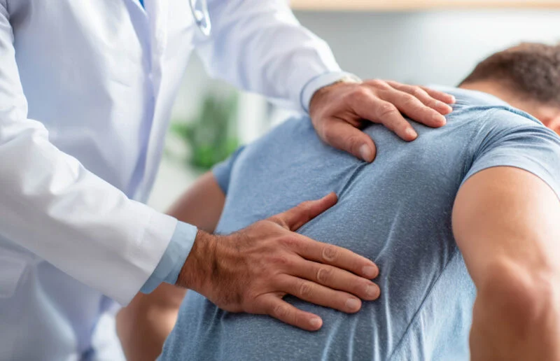 Professional chiropractic care session focusing on spinal alignment and back pain treatment in a modern medical setting | Amarillo Medical Specialists Rheumatology