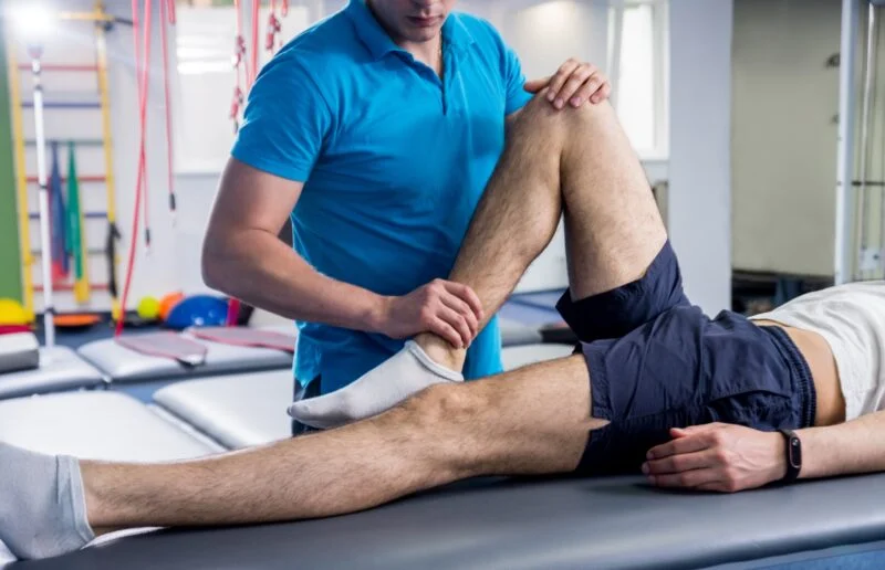 Rehabilitation therapy. Physiotherapist working with young male patient in the rehabilitation center | Amarillo Medical Specialists Rheumatology